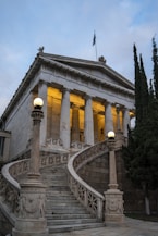 Grand neoclassical building with a sweeping staircase.