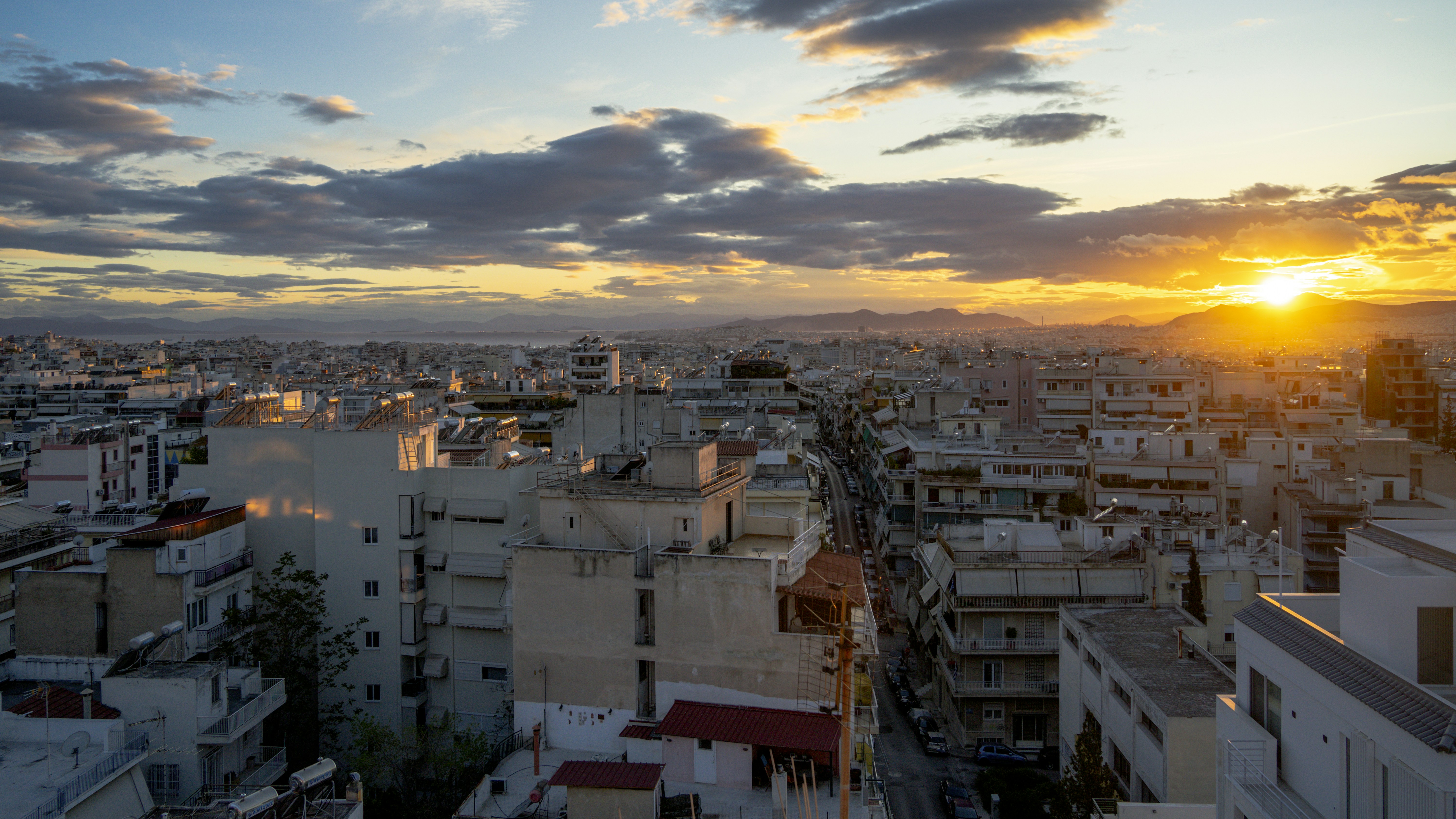 Cityscape at sunset with dramatic clouds