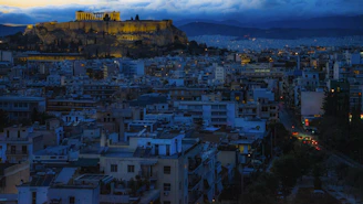 Cityscape with ancient acropolis at dusk.