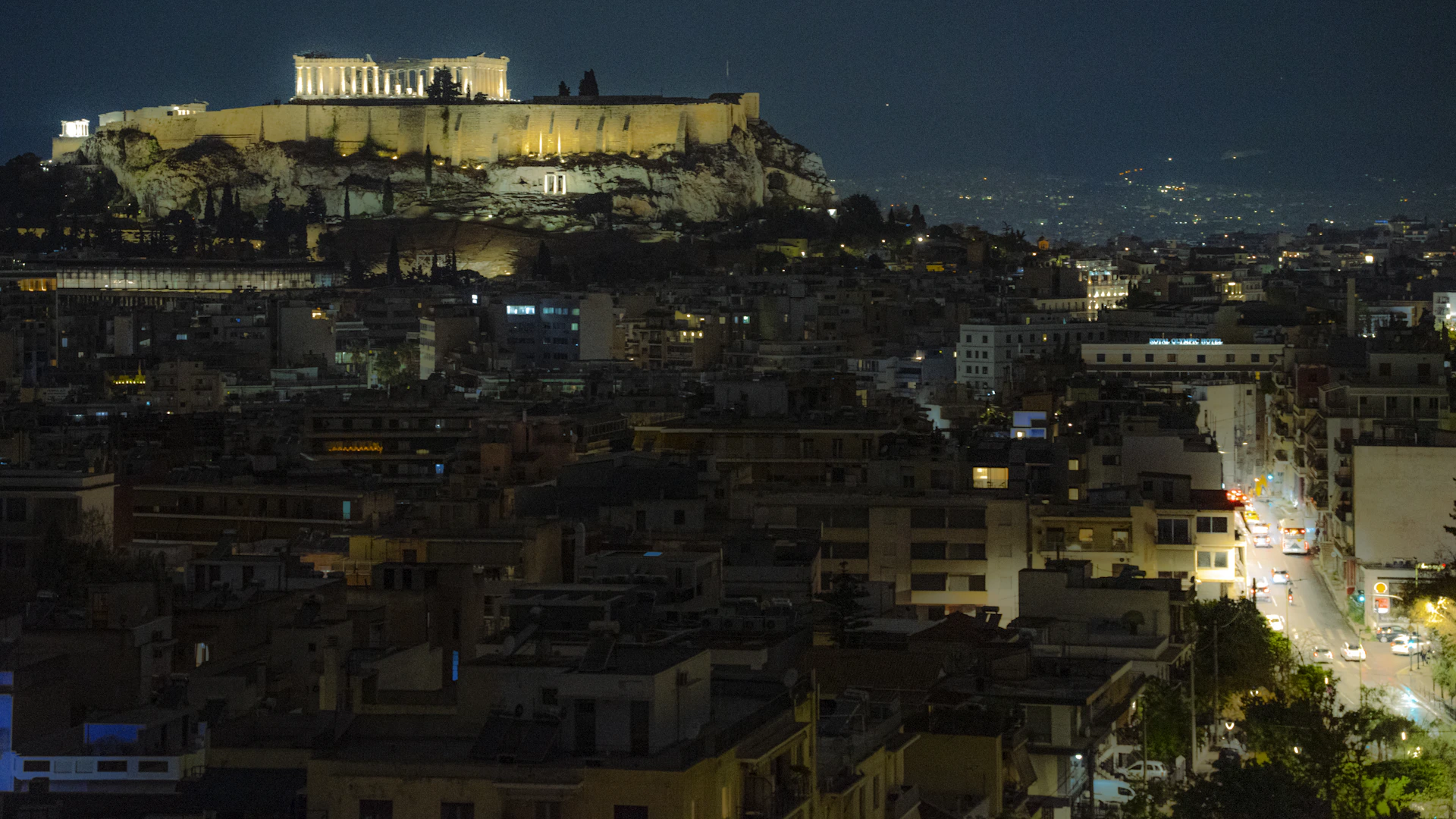The acropolis illuminated at night overlooking athens
