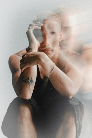 Man with blurred features looking thoughtful