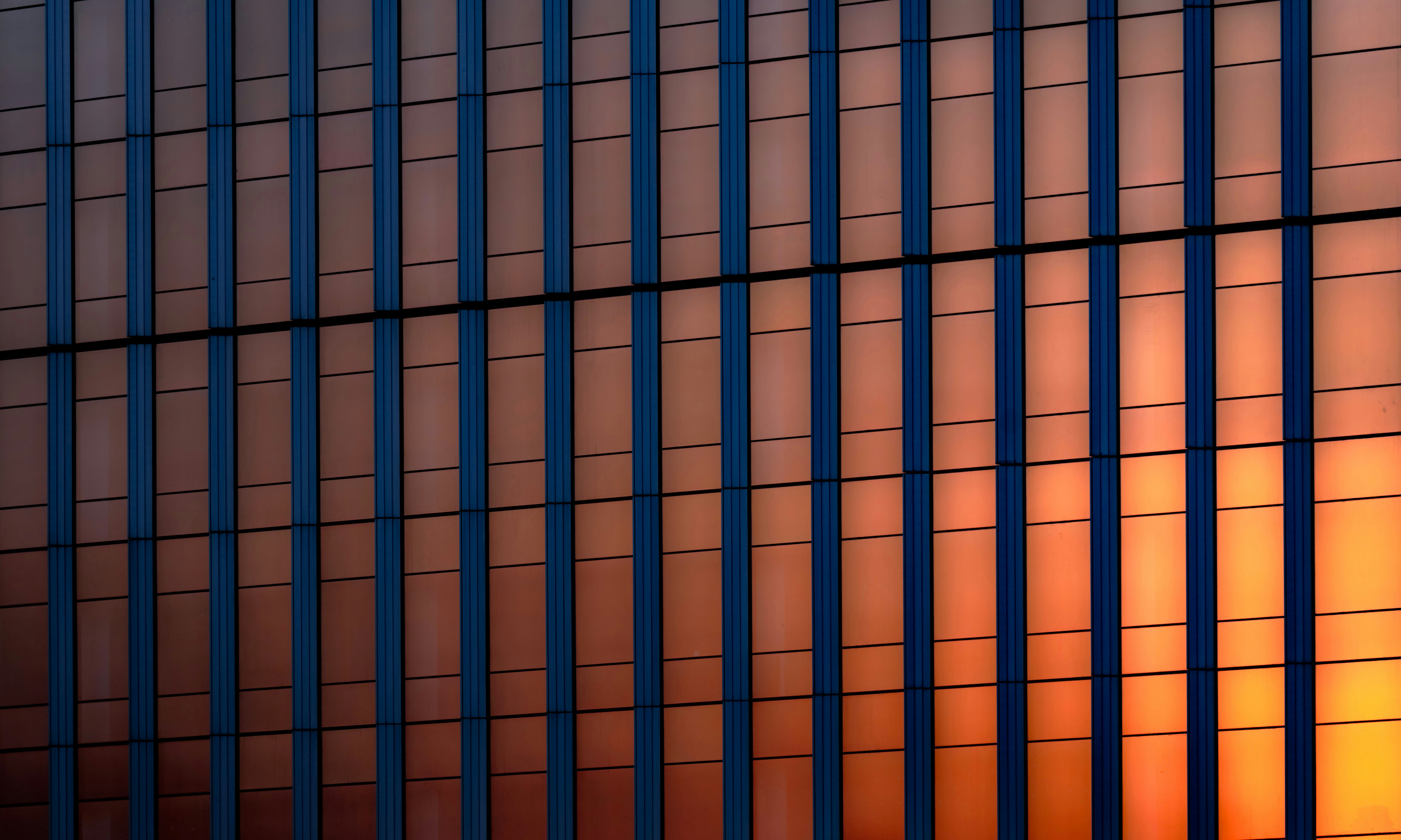 Modern building facade reflecting sunset colors