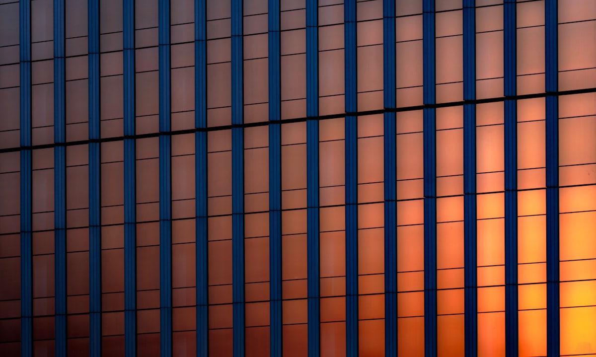Sunset light glowing through a glass curtain wall