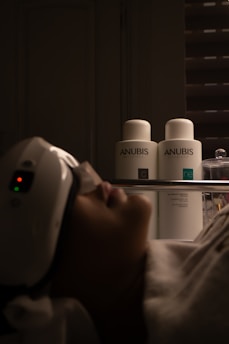 Woman receiving facial treatment with beauty products