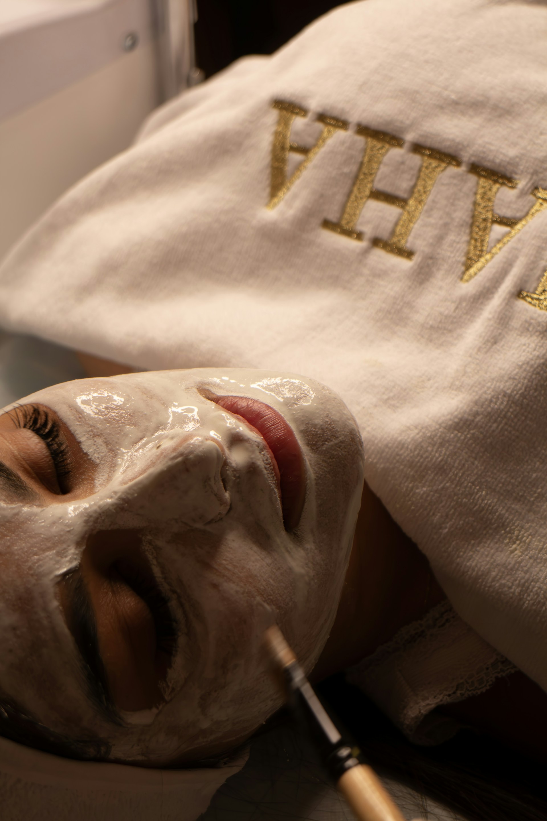 Woman receiving a facial treatment with a brush