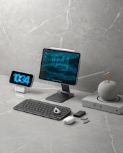 Digital devices and accessories on a marble desk.