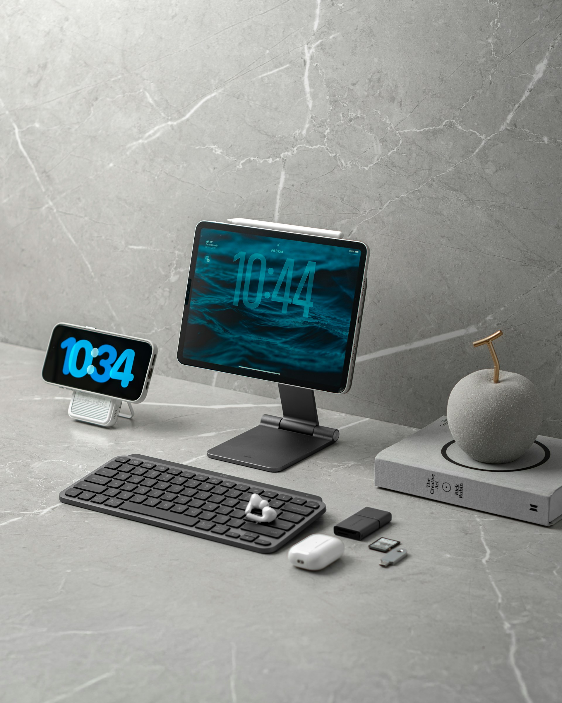Digital devices and accessories on a marble desk.