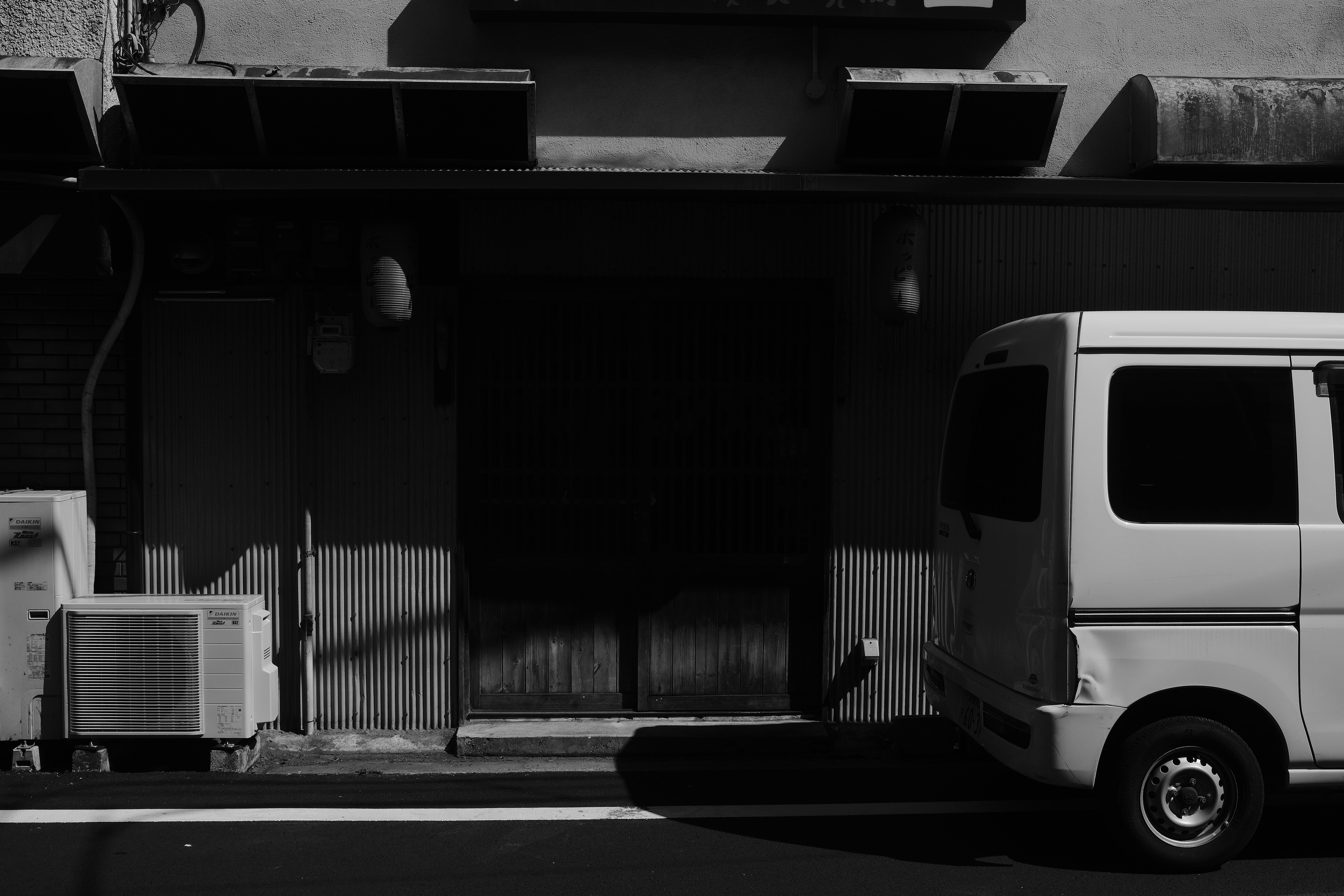 A white van parked on a street.