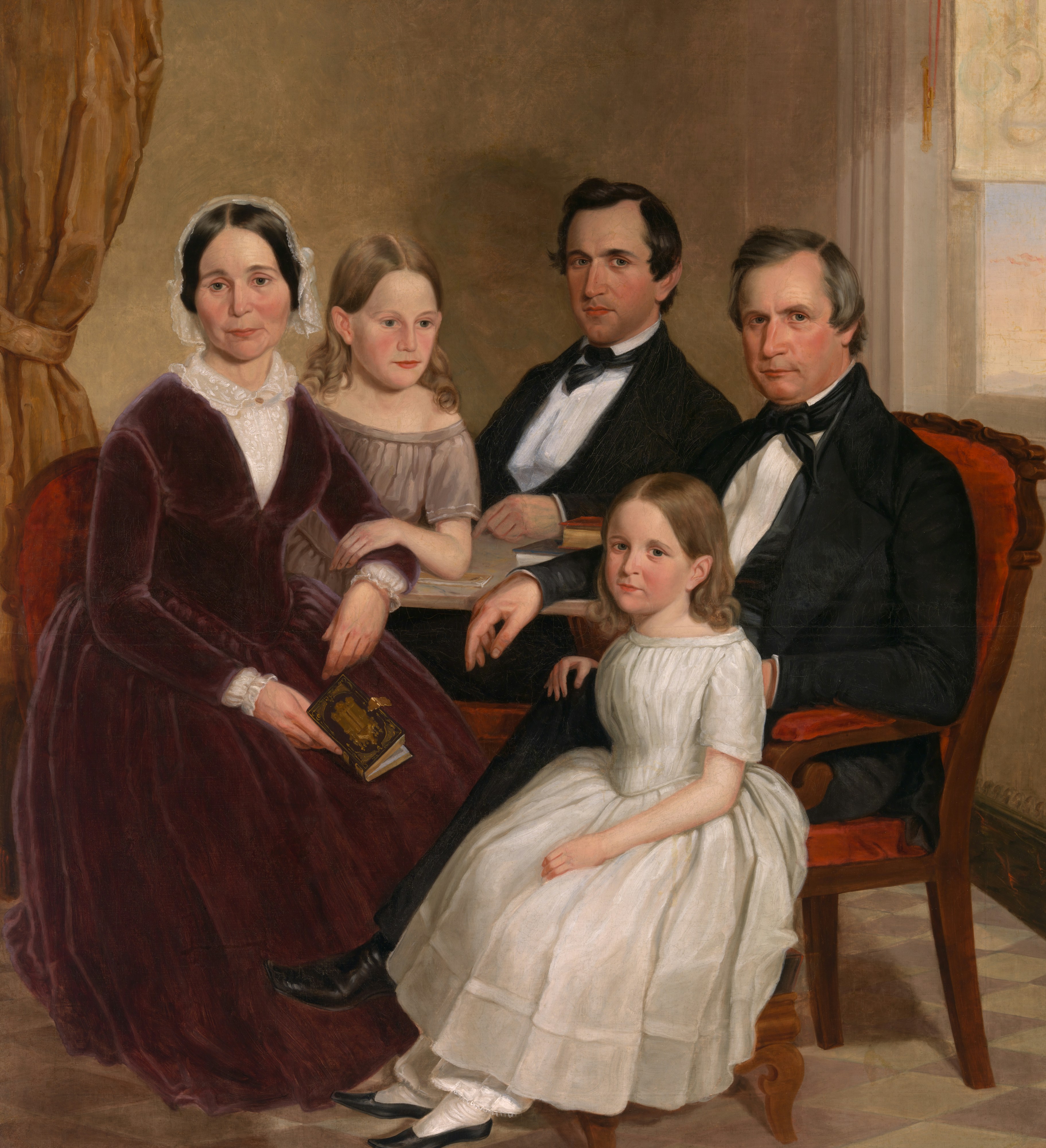 A formal portrait of a family in victorian attire