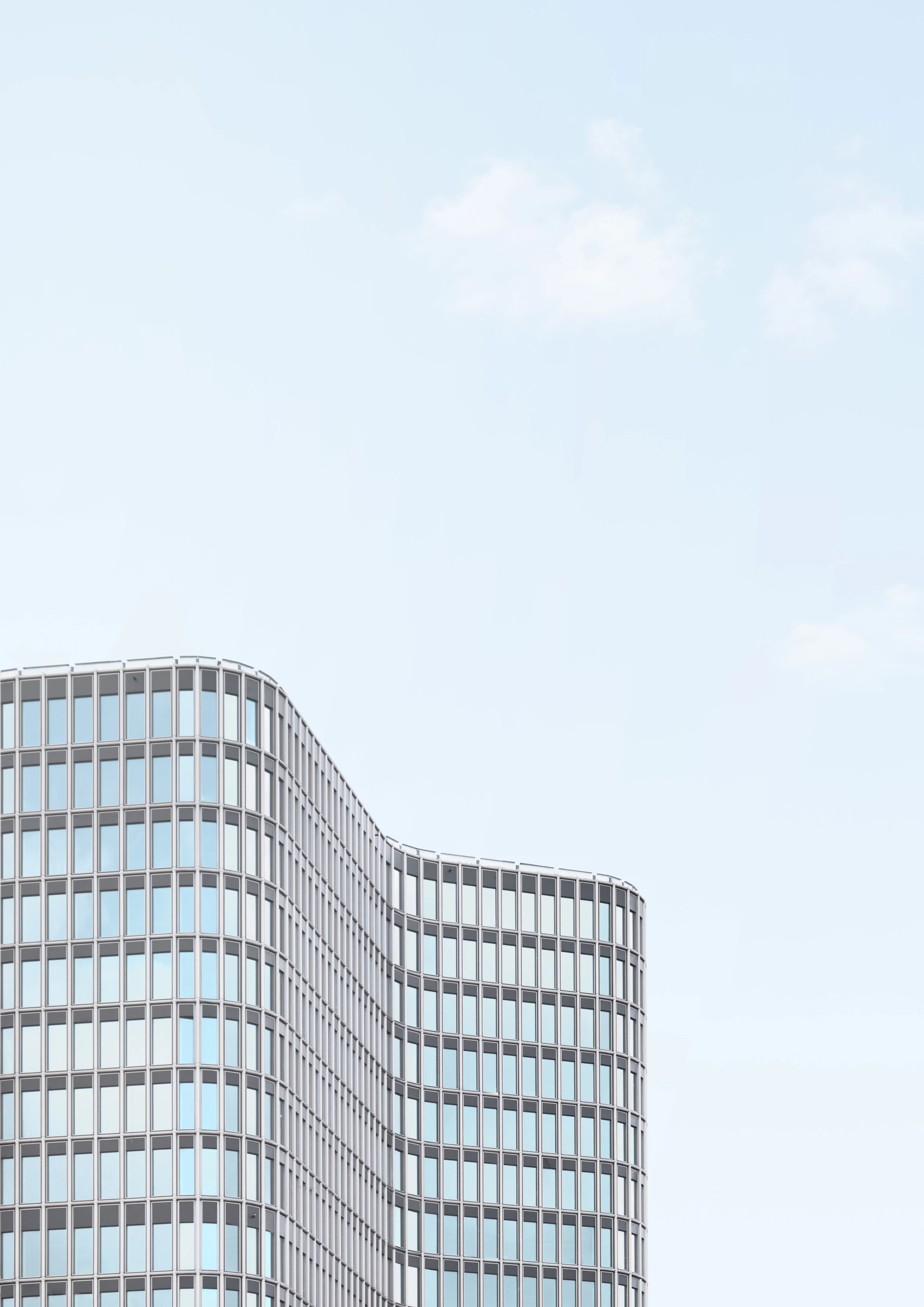 Modern glass building against a clear sky