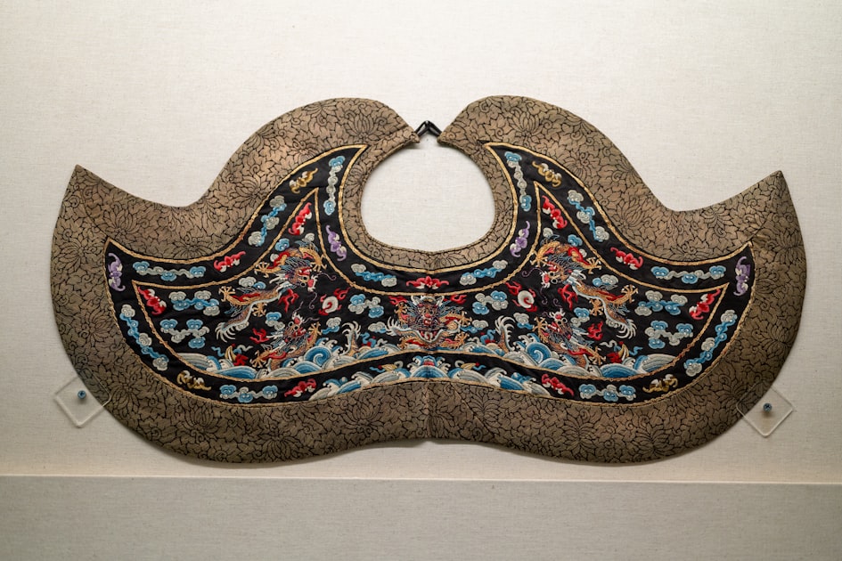 Ornate embroidered collar with colorful floral and animal motifs — the same visual language carried forward into contemporary Chinese-style bag design.
