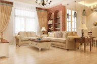 Elegant living room with plush sofas and brick accent wall.
