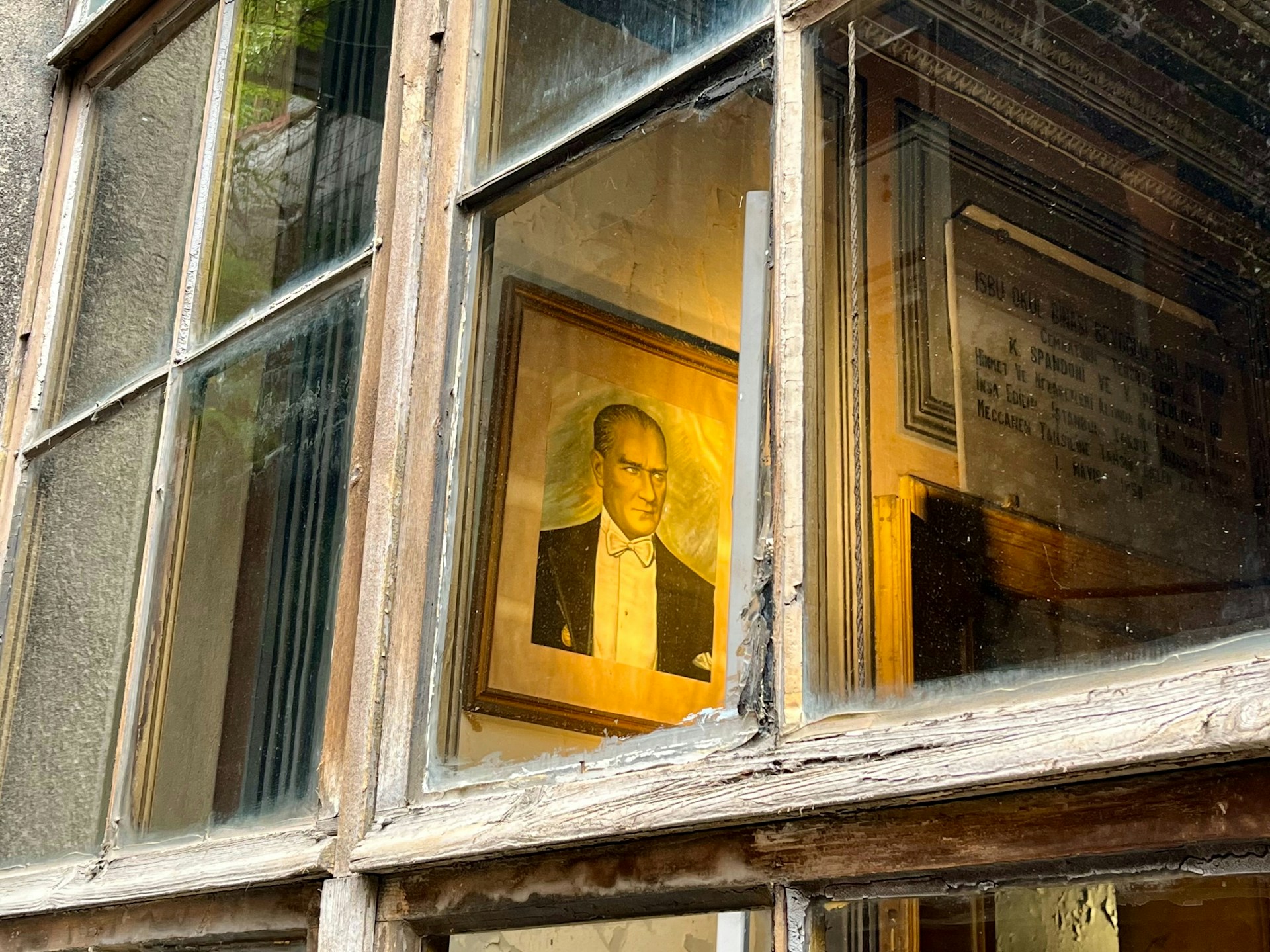 Portrait seen through a dusty, broken window pane