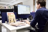 Man working at a computer in an office.