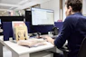 Man working at a computer in an office.