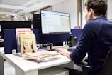 Man working at a computer in an office.