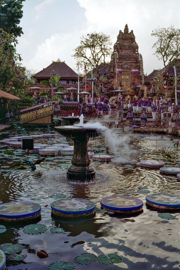 Fountain and lotus pond before Balinese temple architecture in Ubud