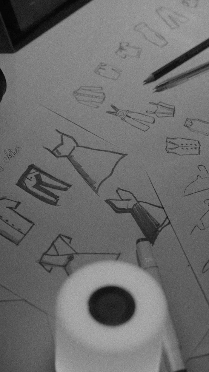 Clothing design sketches with pencils on the drafting table