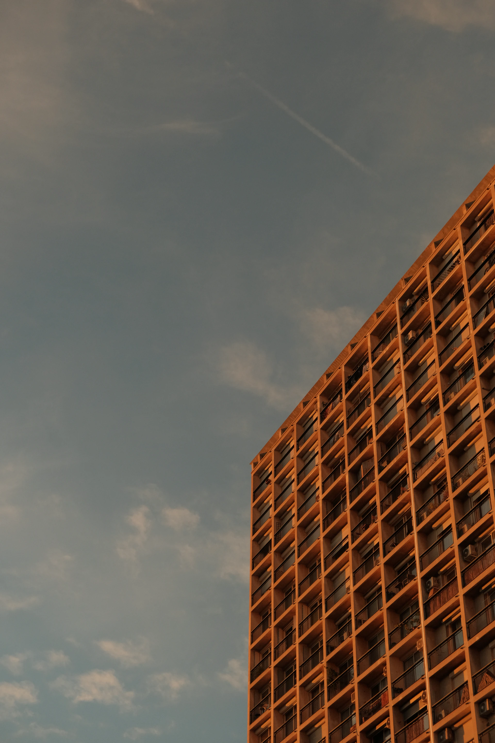 Modern building facade against a cloudy sky