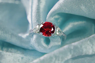 A ruby and diamond ring on blue silk