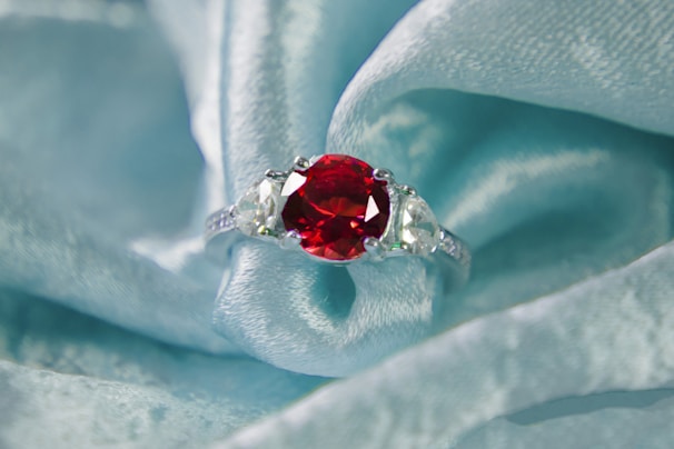 A ruby and diamond ring on blue silk