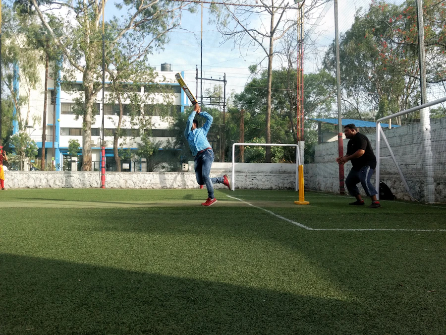 Batter playing box cricket on an enclosed turf with friends