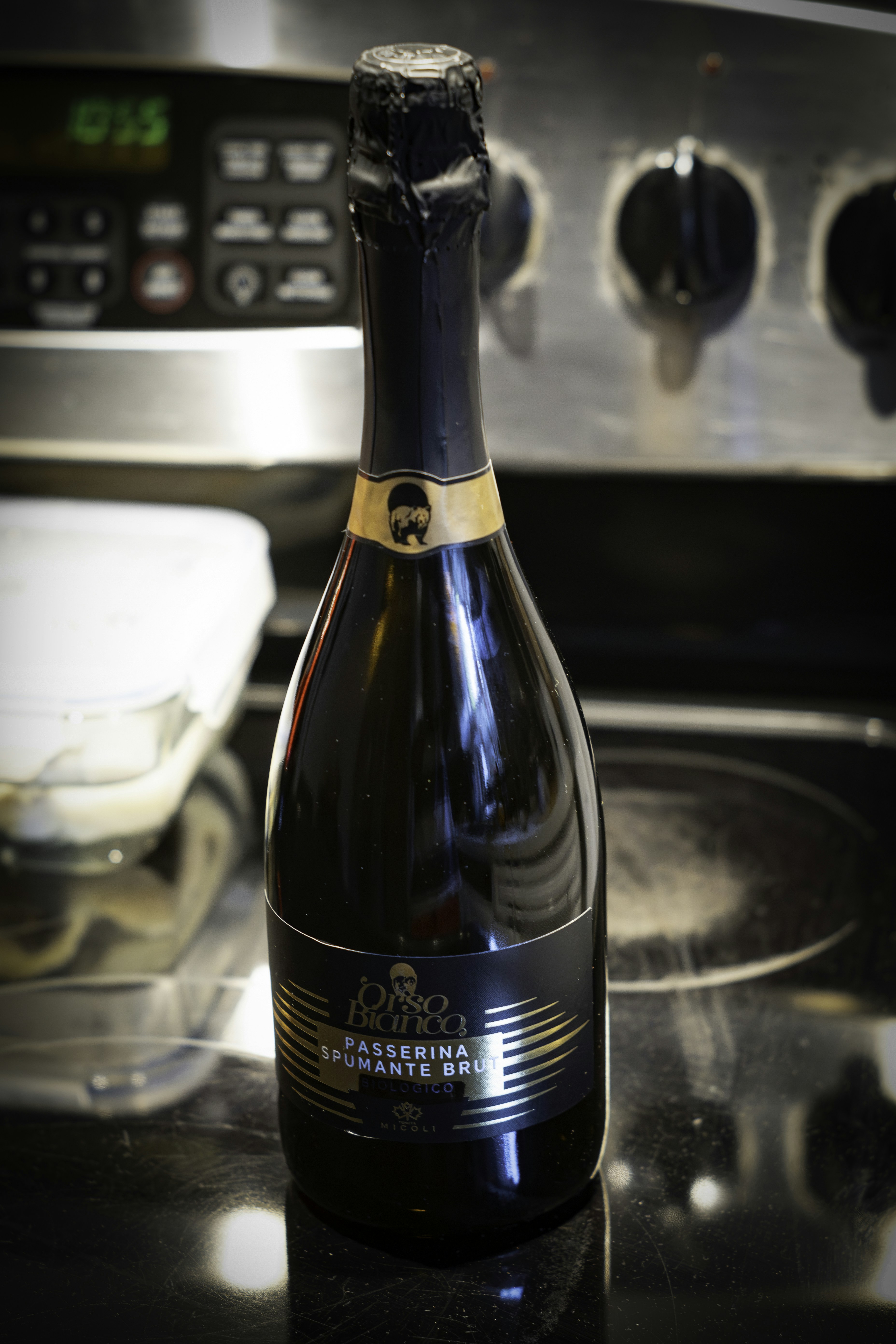 Bottle of sparkling wine on a kitchen counter