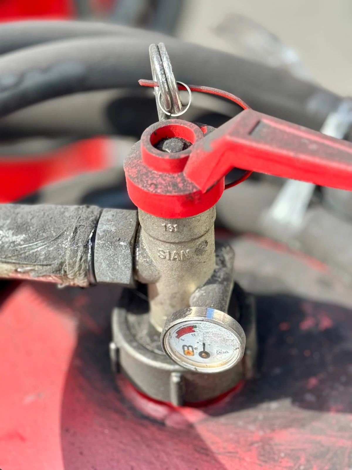 Close-up of an industrial valve with pressure gauge