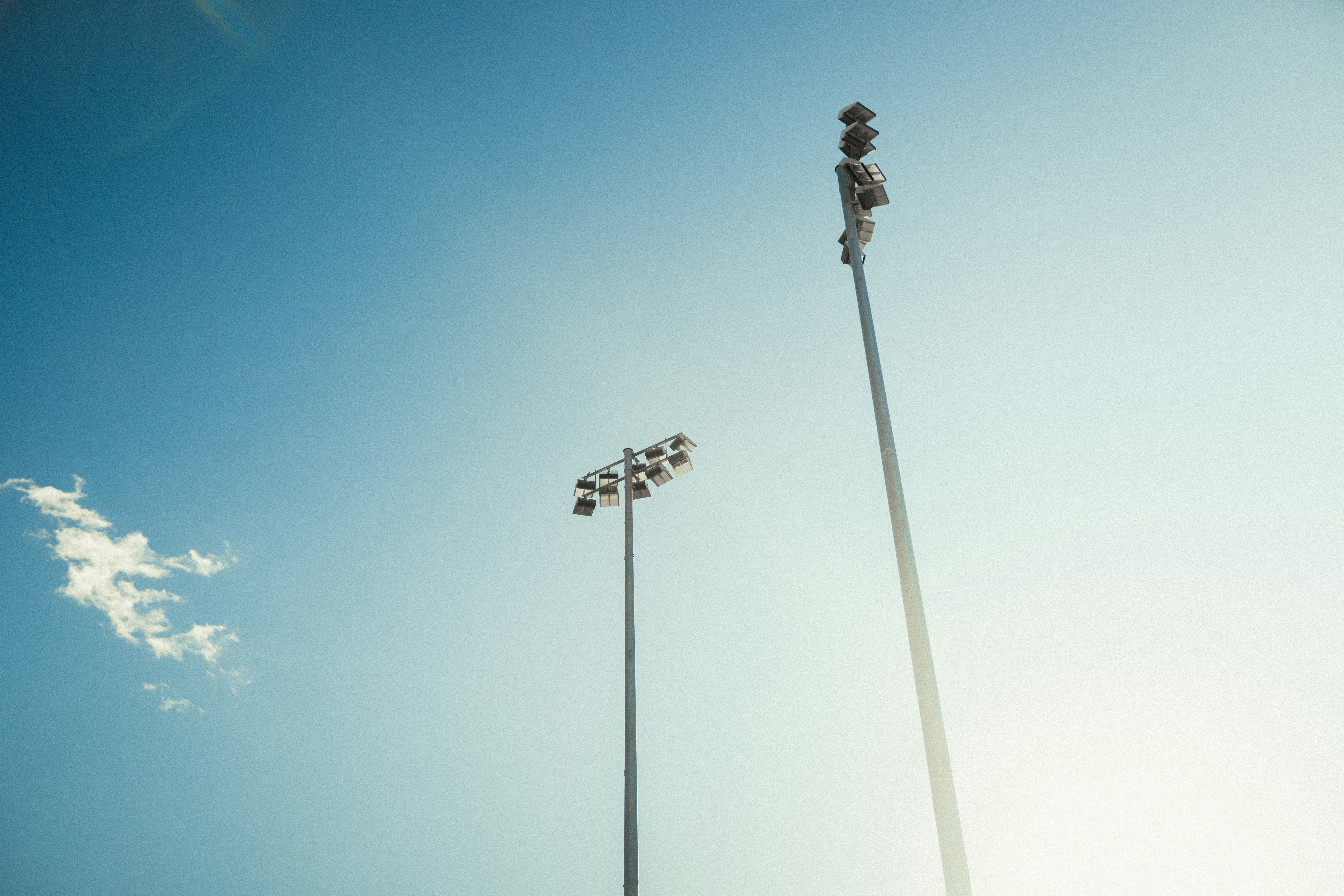 Stadium lights against clear blue sky