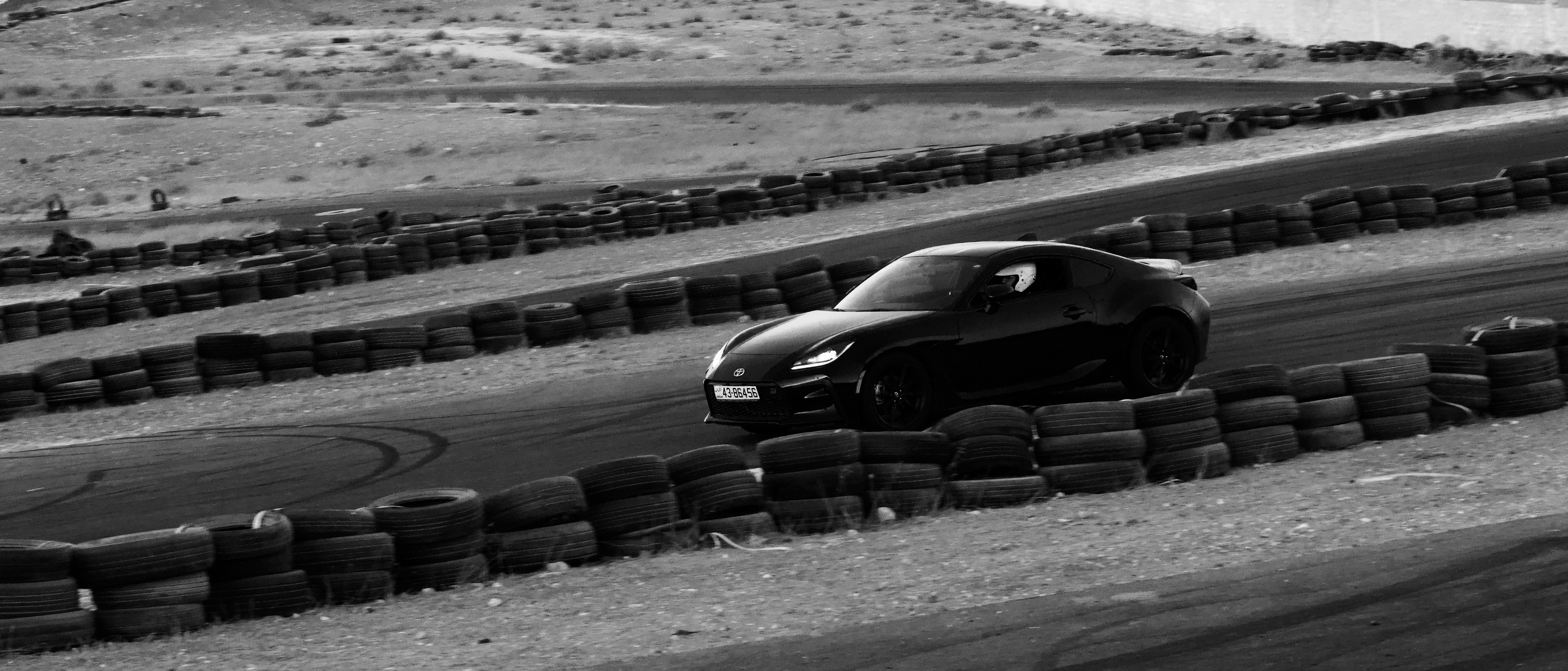 Black sports car driving on a race track