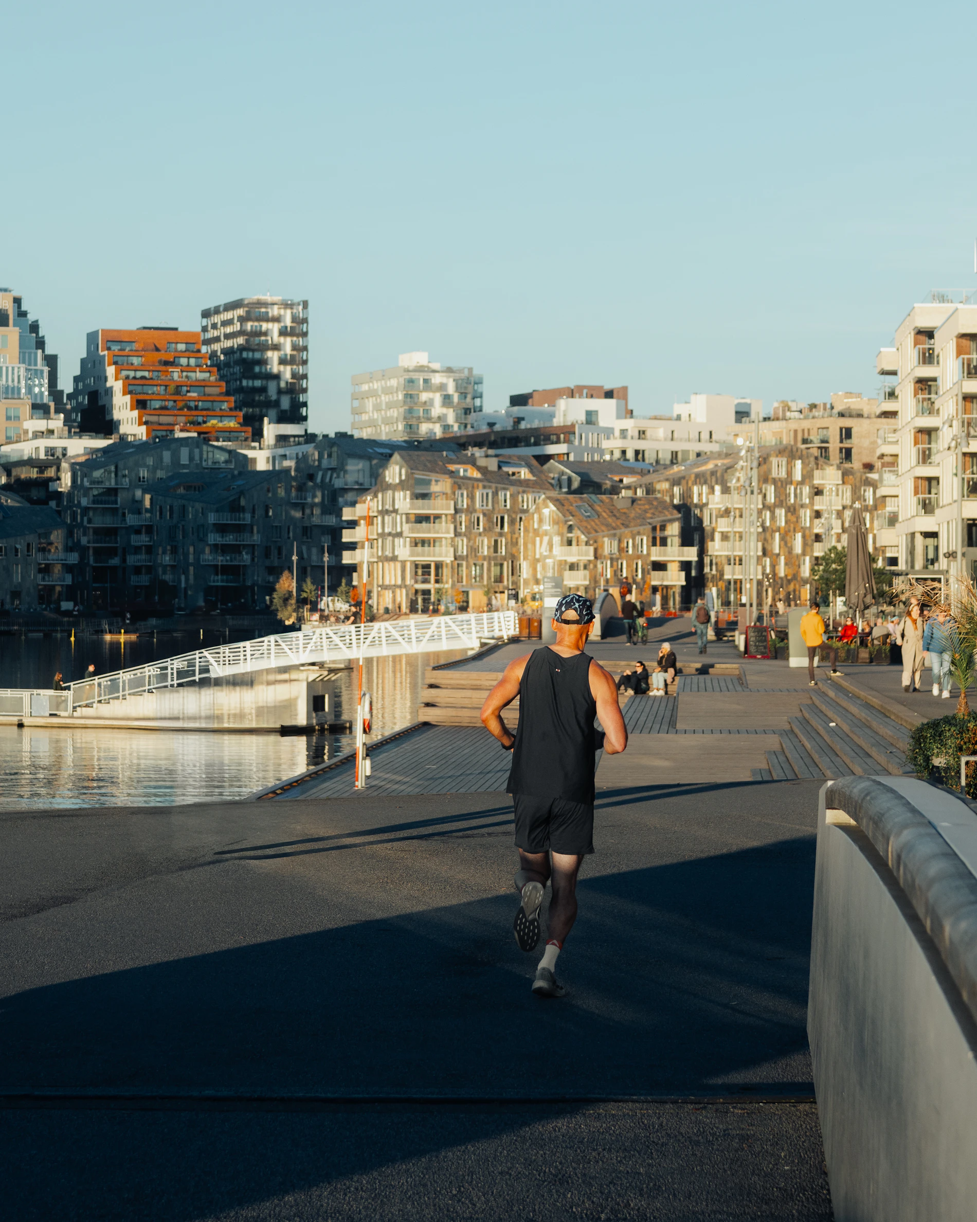 Runner moving along an urban waterfront during an outdoor training session