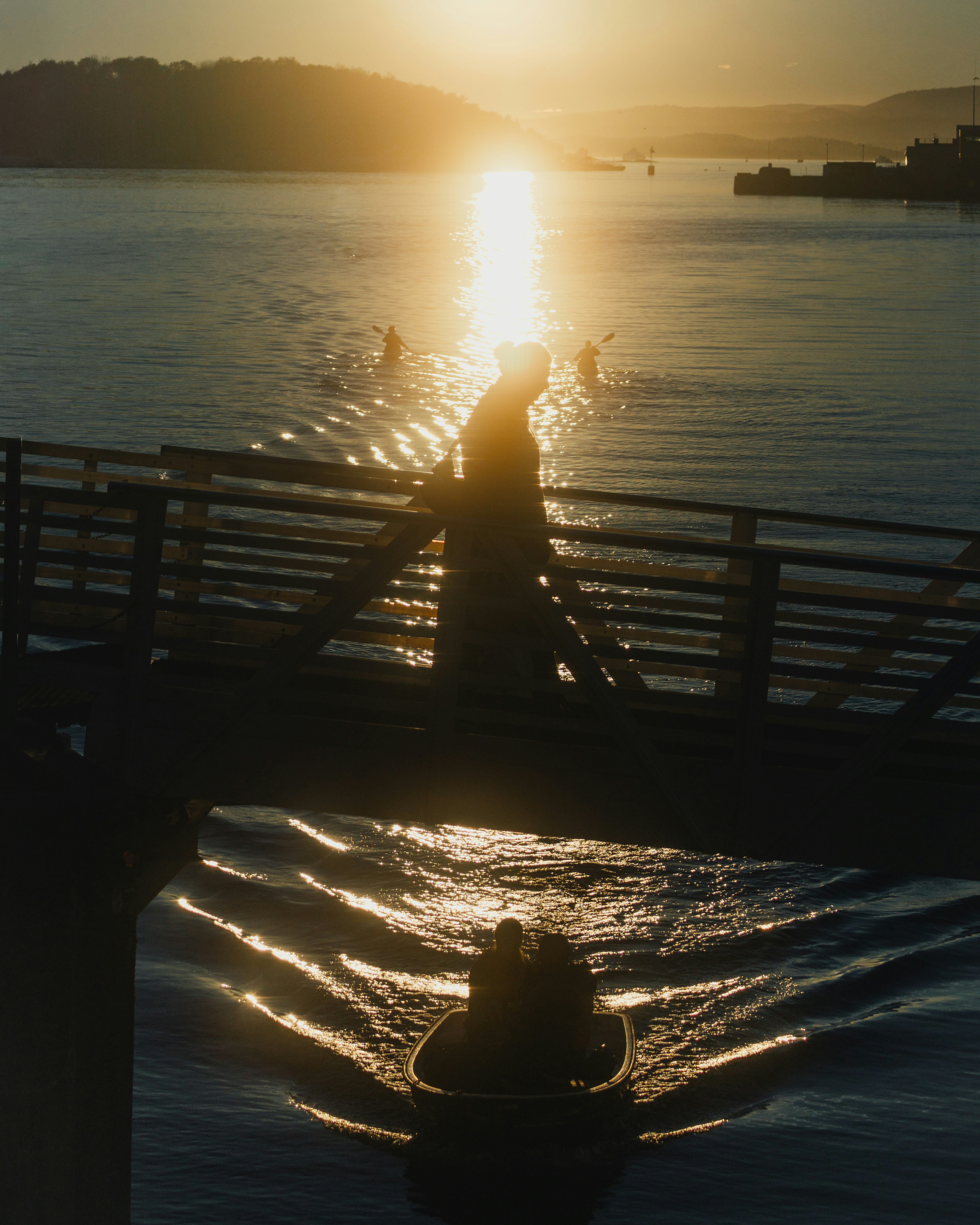 Sunset over a calm ocean with boats