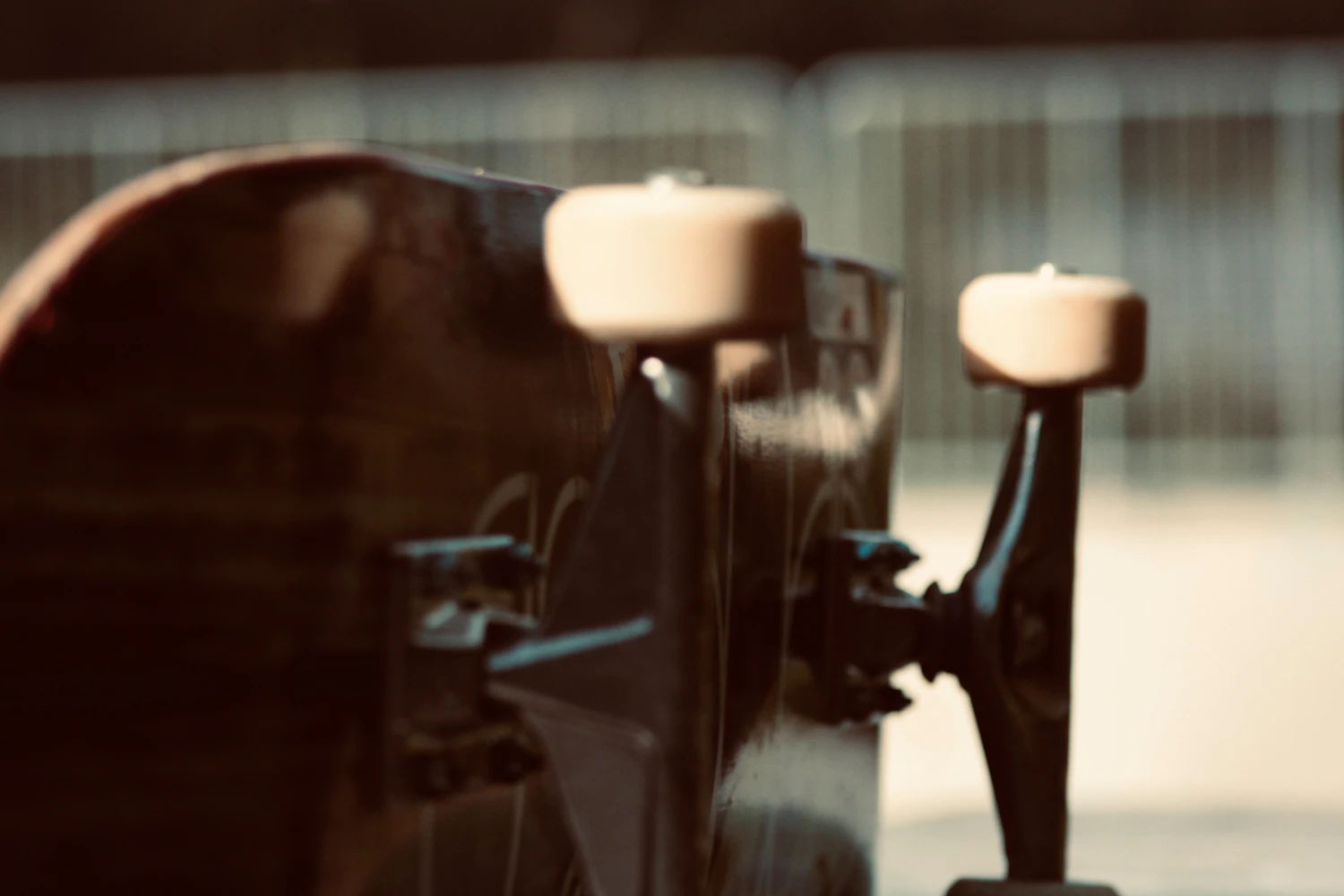 Flat Bar trucks, the axle and hanger photographed close up against the light