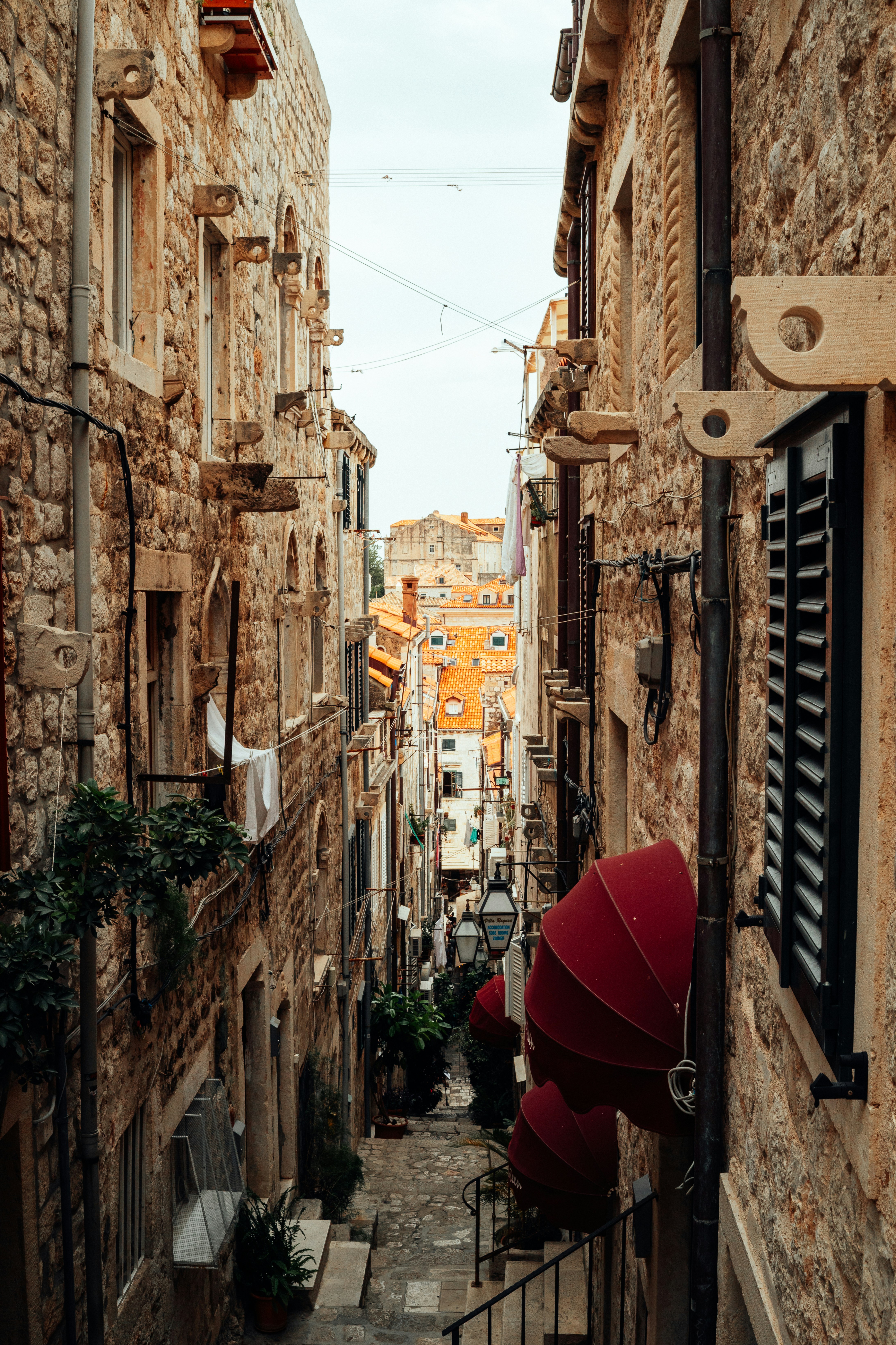 Narrow cobblestone street between old stone buildings.
