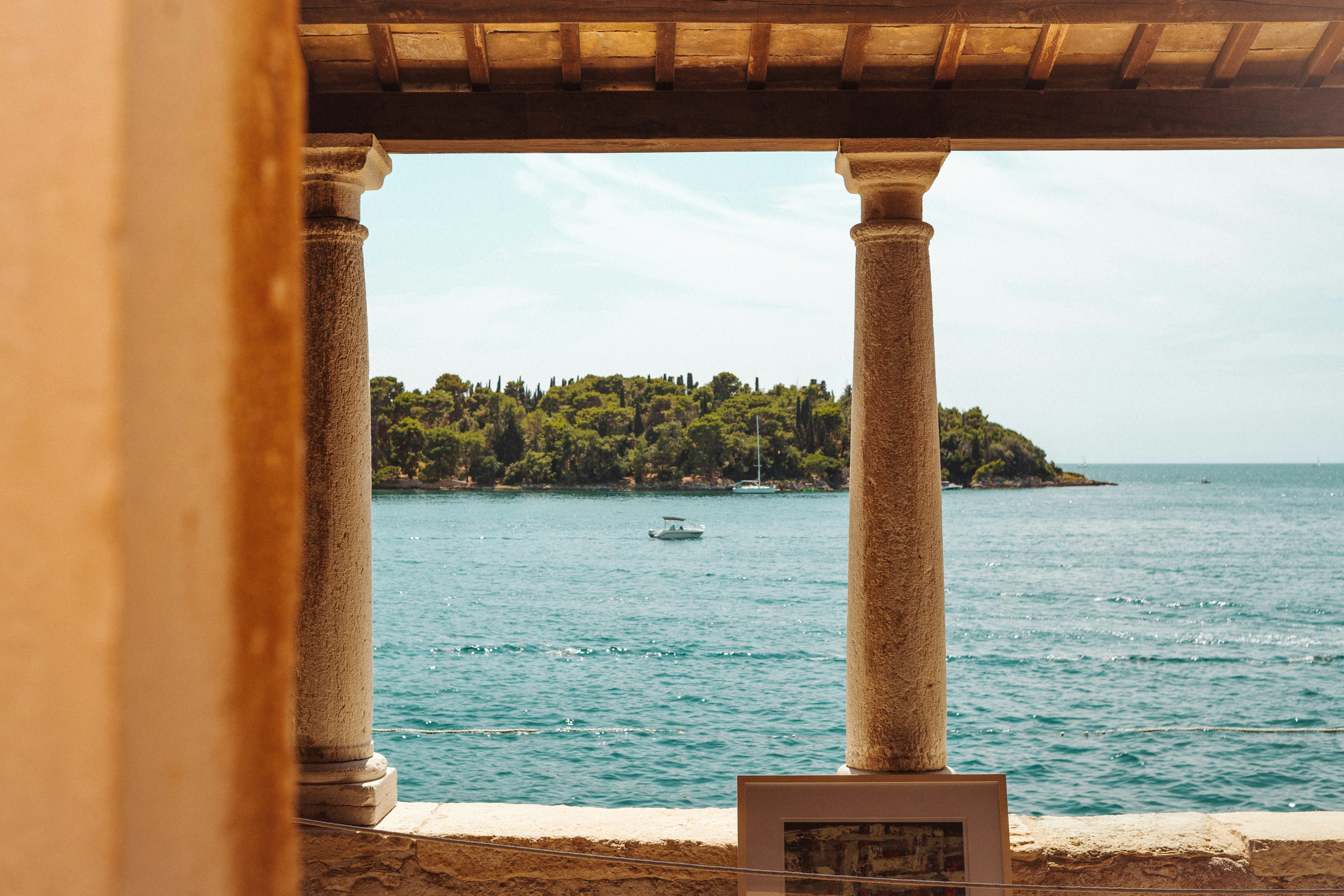 View of island and boat through columns