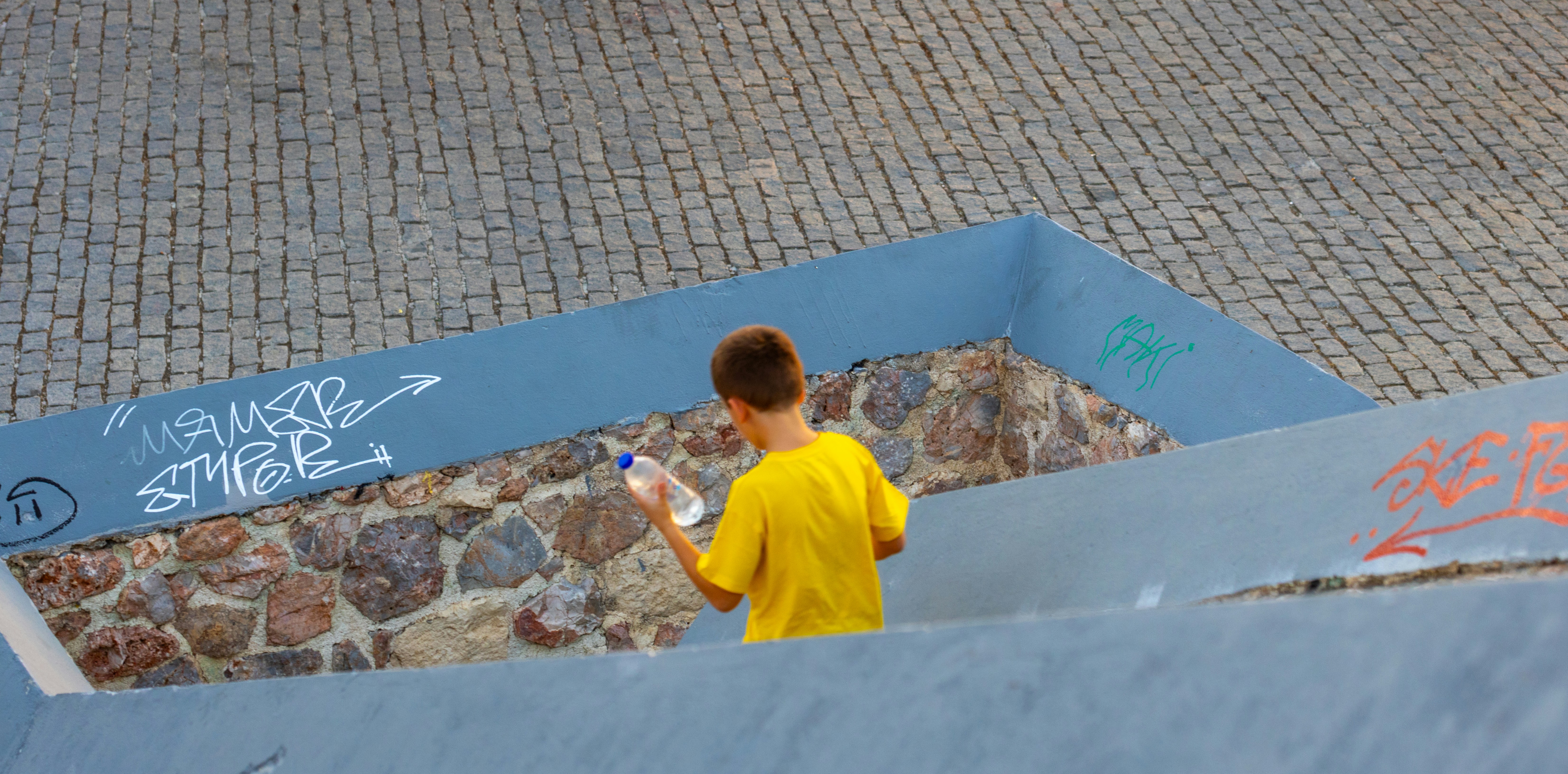 Person sealing a patio slab for maintenance