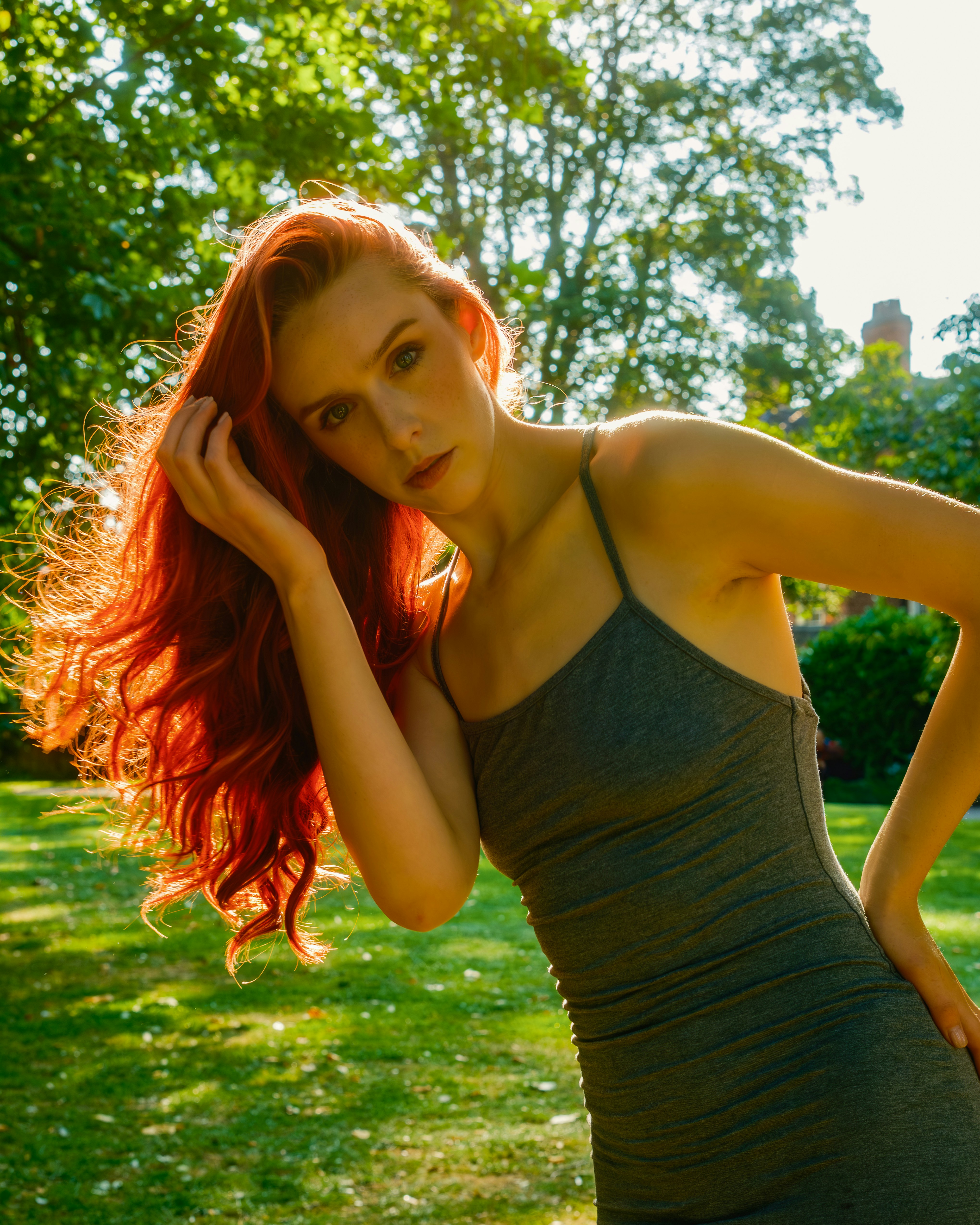 Woman with long red hair in a park