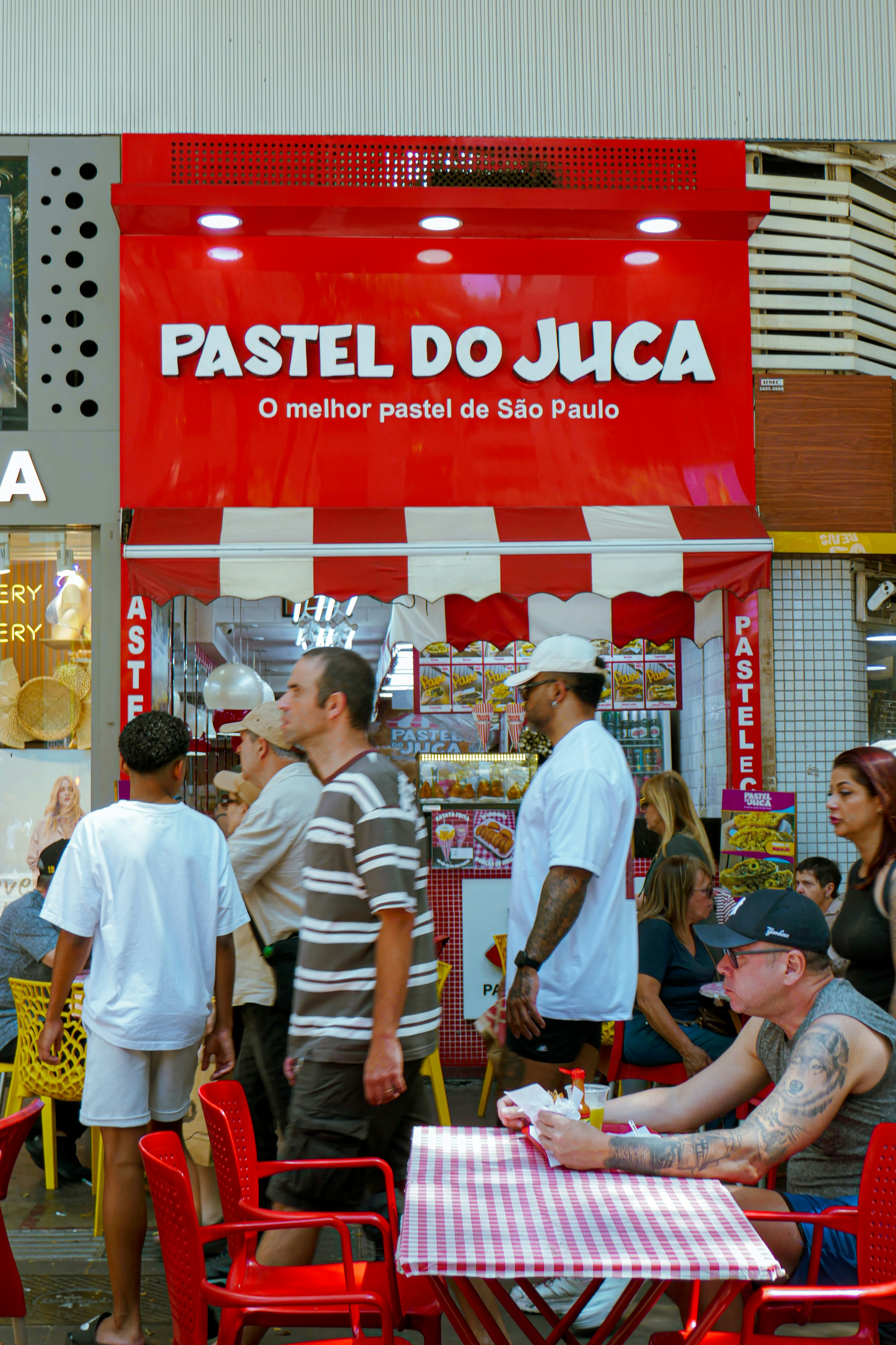 People gathered outside a pastel shop in são paulo