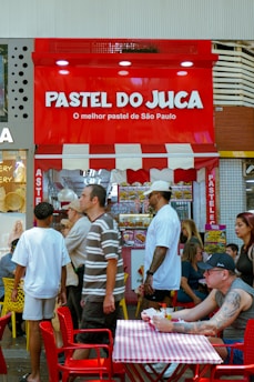 People gathered outside a pastel shop in são paulo