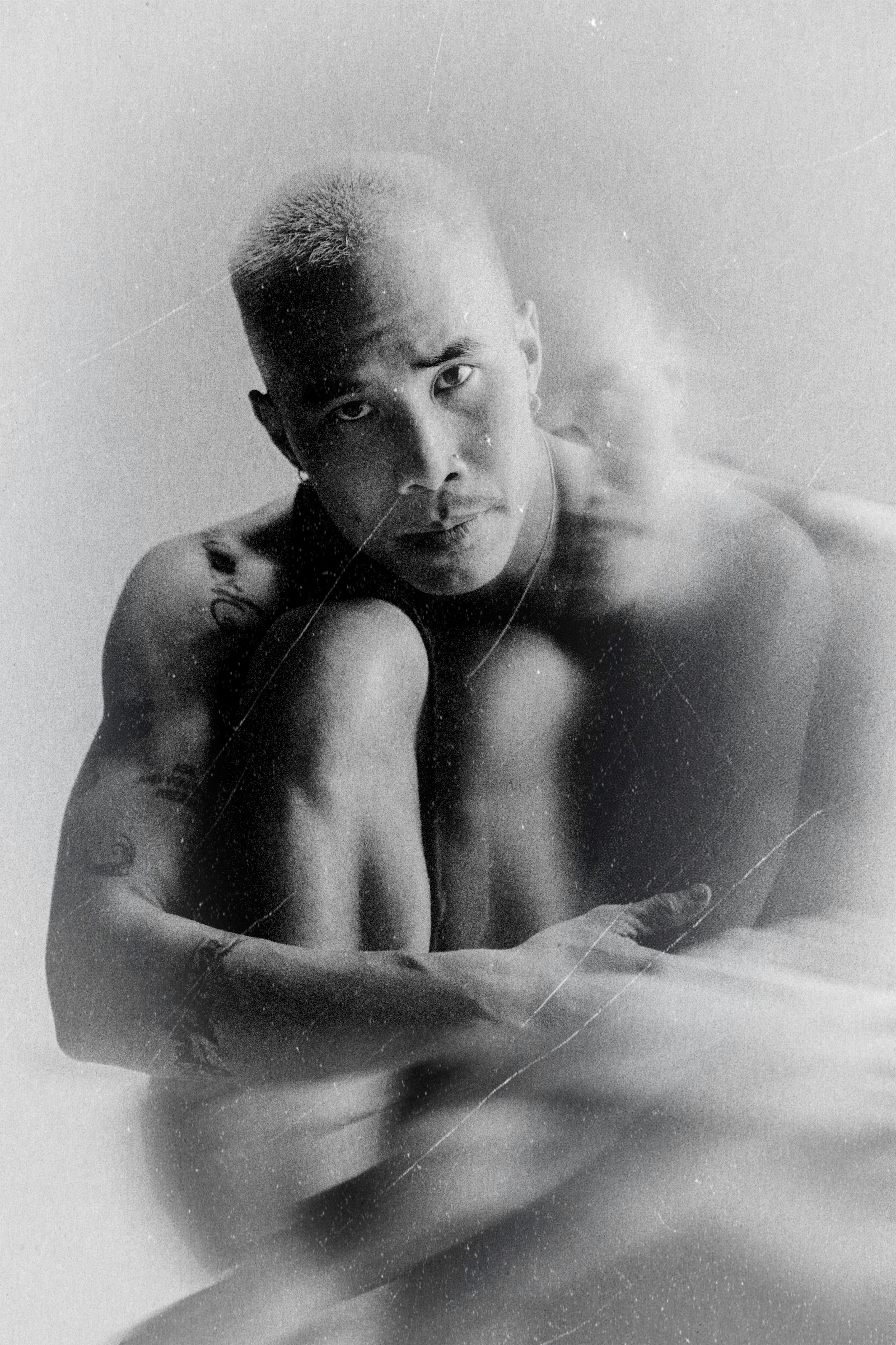 Man with blurred figure behind him