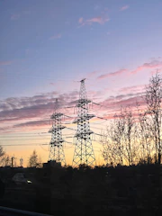 Power lines against a colorful sunset sky