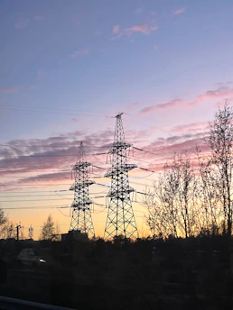 Power lines against a colorful sunset sky