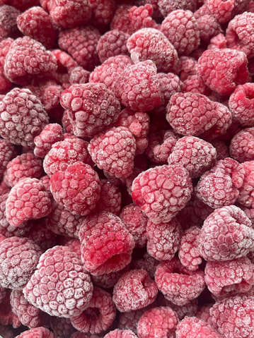 Frozen raspberries close-up background