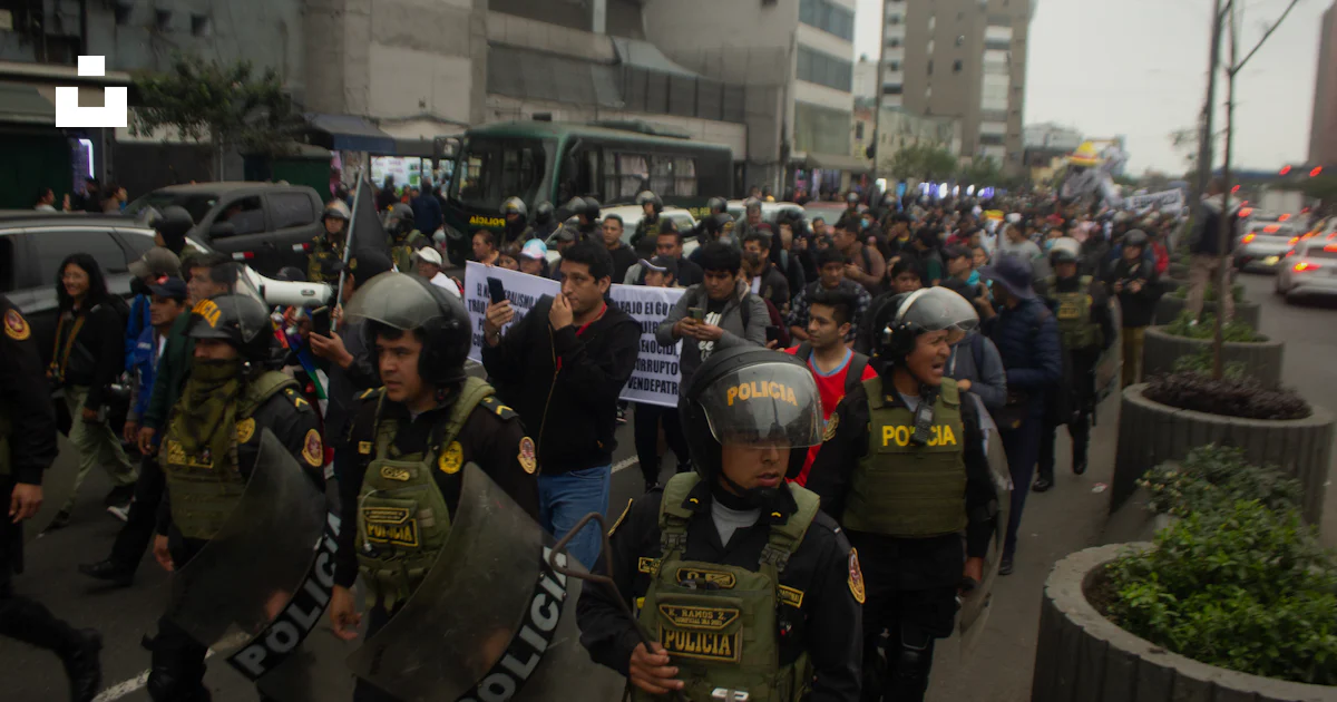 Police Injustice Riot Police in riot gear march with protesters on a street. photo – Free ...