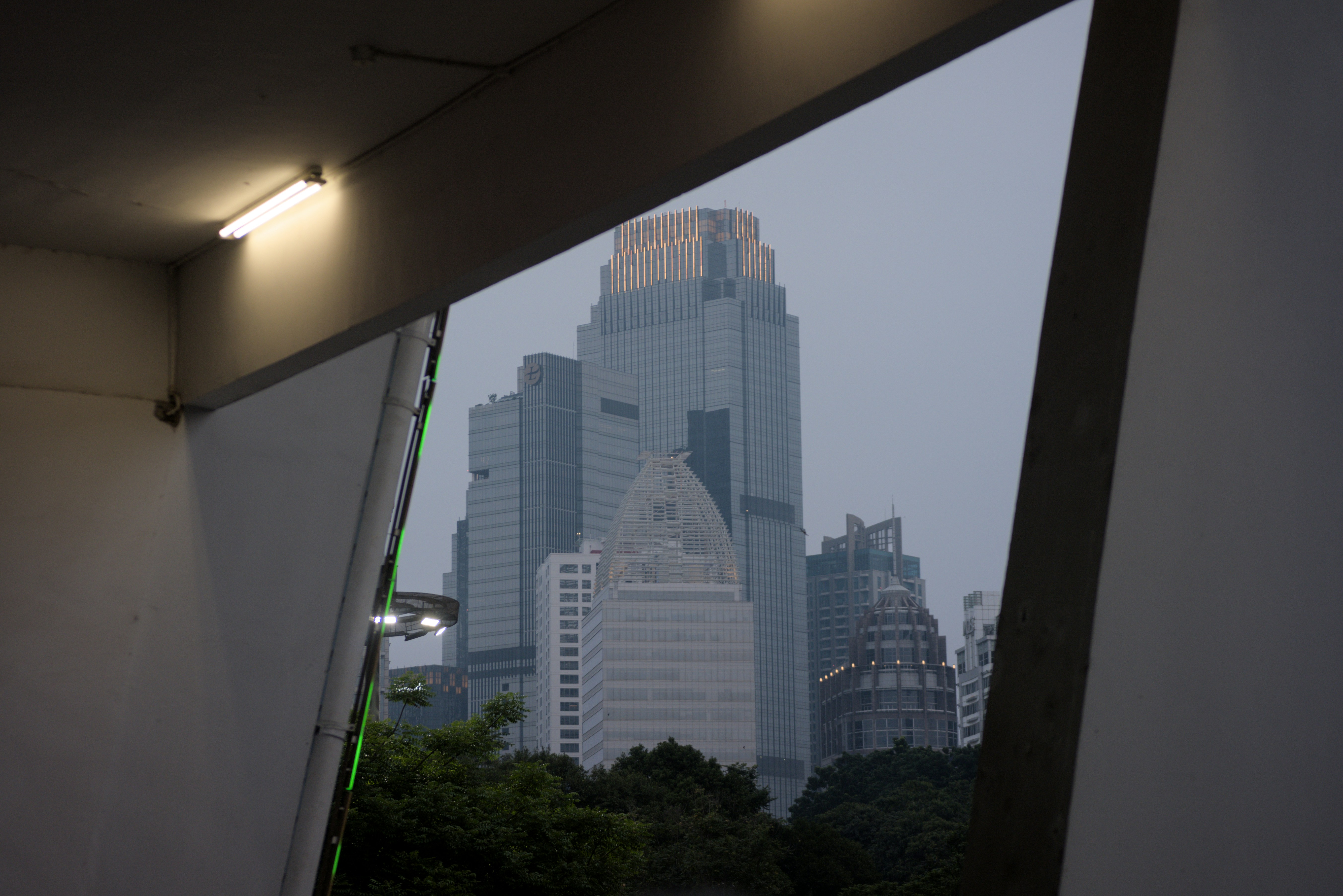Modern skyscrapers viewed through a window frame.