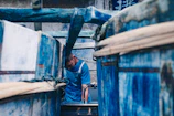 Worker dyeing fabric in a workshop