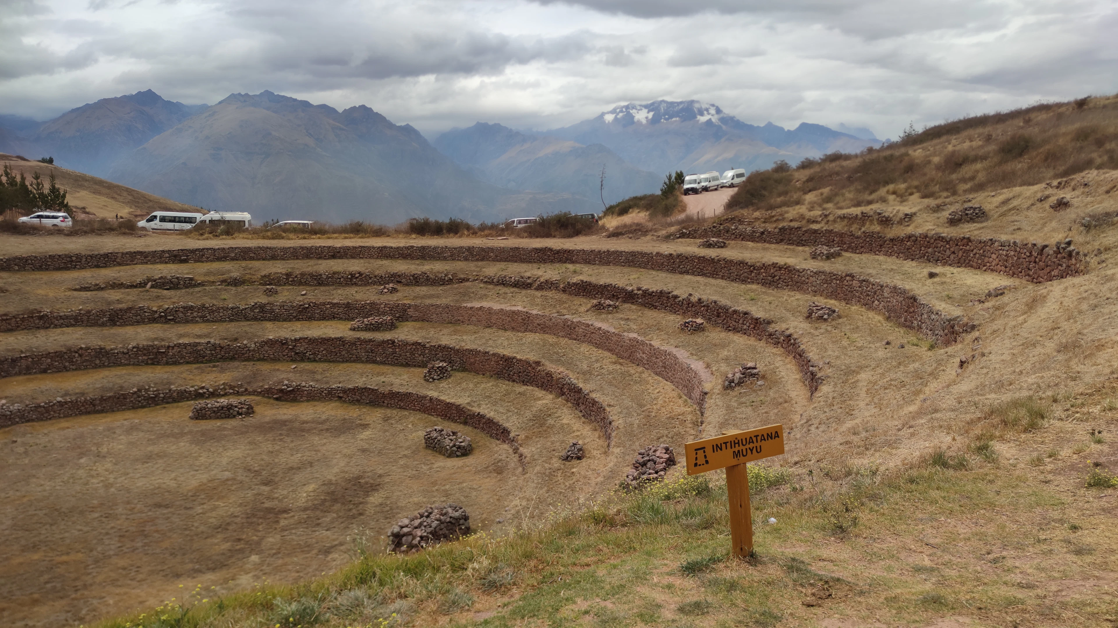 Circular Inca agricultural terraces at Moray in the Sacred Valley, with Andean peaks beyond