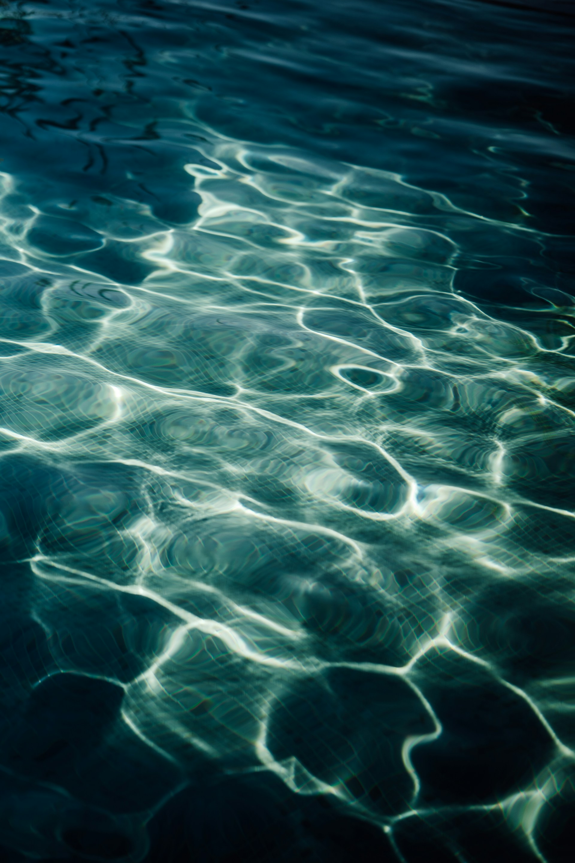 Sunlight reflecting on dark blue water surface