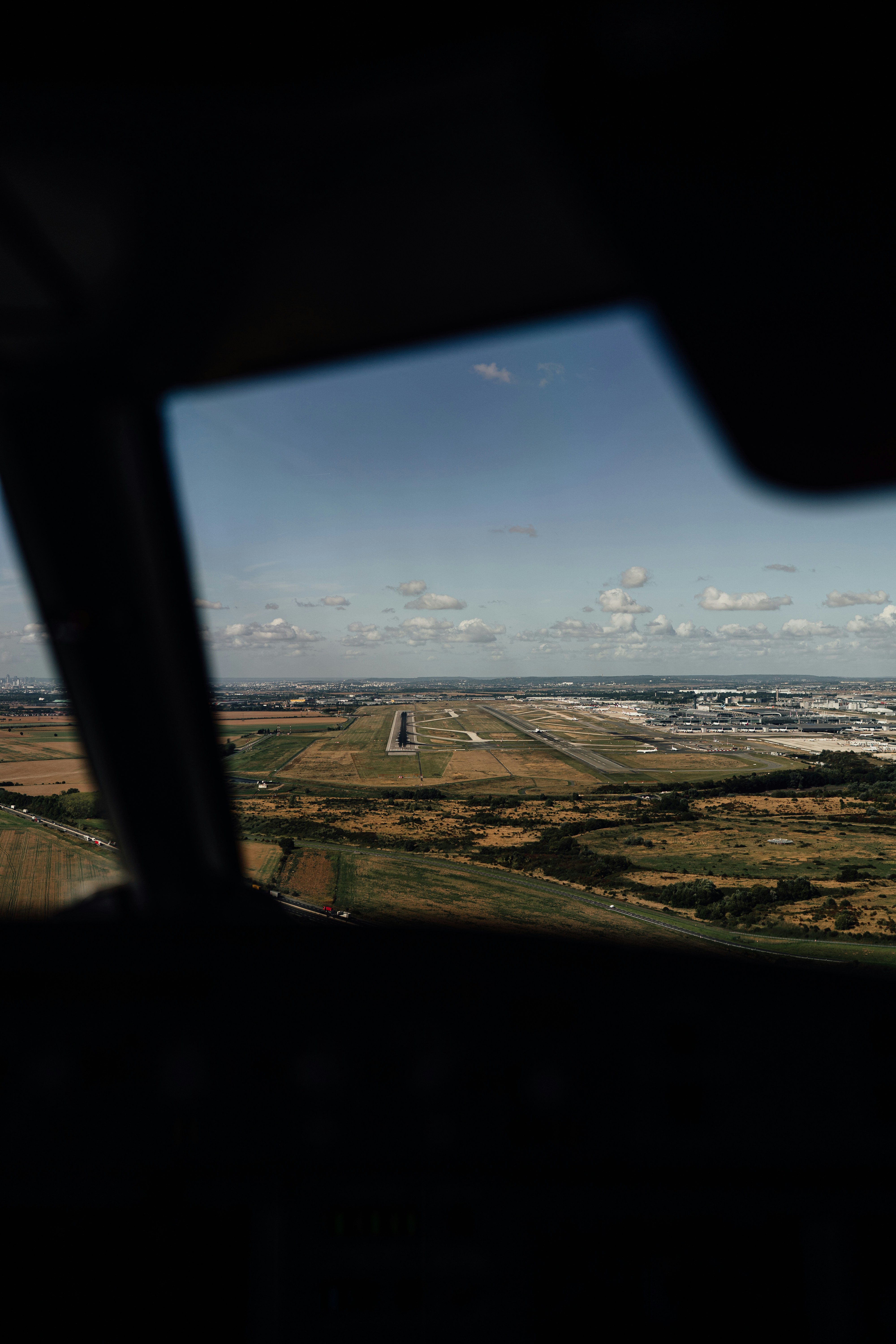 View of airport runway from airplane cockpit window