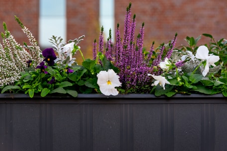 A planter box filled with colorful flowers and greenery.